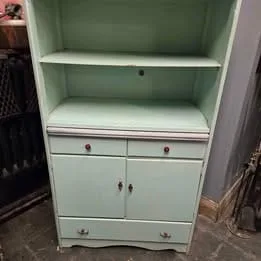 Beautifully painted antique Hoosier cupboard with storage compartments and classic detailing.