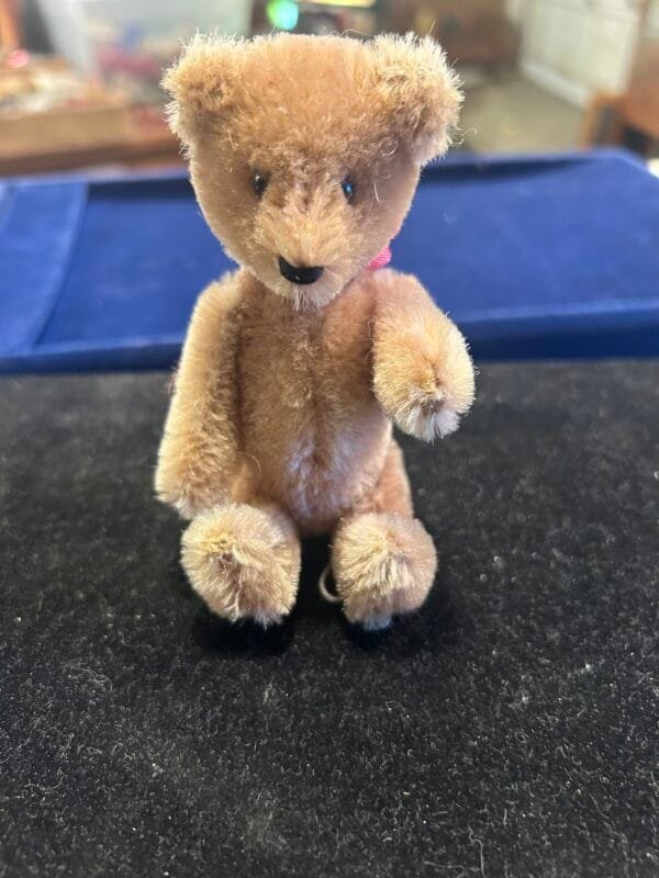 Vintage 5-inch Schuco mohair bear with glass eyes and a rare nodding mechanism.